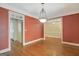 Spacious dining room with hardwood floors and views into kitchen and another room at 305 Sherwood Rd, Fayetteville, GA 30215
