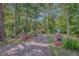 Long, paved driveway leading to a home surrounded by mature trees at 305 Sherwood Rd, Fayetteville, GA 30215