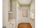 Hallway featuring built-in cabinets and a countertop, leading to an exterior door and a laundry room at 305 Sherwood Rd, Fayetteville, GA 30215