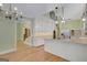Open kitchen with a large island, stainless steel appliances, and hardwood floors leading to adjacent rooms at 305 Sherwood Rd, Fayetteville, GA 30215