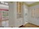 Kitchen area showcasing built-in cabinetry, a view into a bright living space, and a glimpse into a laundry room at 305 Sherwood Rd, Fayetteville, GA 30215
