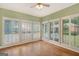 Living room with hardwood floors and shuttered windows overlooking the inviting pool at 305 Sherwood Rd, Fayetteville, GA 30215