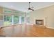Sunlit living room with a brick fireplace and large windows overlooking the well-manicured backyard at 305 Sherwood Rd, Fayetteville, GA 30215