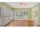 Bright living room with hardwood floors and shuttered windows overlooking the beautiful backyard at 305 Sherwood Rd, Fayetteville, GA 30215