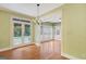 Open living space features a chandelier, French doors to a pool, and large shuttered windows at 305 Sherwood Rd, Fayetteville, GA 30215