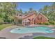 Backyard oasis featuring a private pool, patio with outdoor dining set, and mature trees for added seclusion at 305 Sherwood Rd, Fayetteville, GA 30215