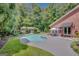 Stunning backyard with a pristine pool, an outdoor dining area, and a charming outdoor fireplace area at 305 Sherwood Rd, Fayetteville, GA 30215