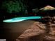 Inviting backyard pool illuminated at night, perfect for relaxation and evening swims at 305 Sherwood Rd, Fayetteville, GA 30215