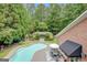 Aerial view from the balcony of the backyard pool, patio area, fireplace, and lush greenery at 305 Sherwood Rd, Fayetteville, GA 30215