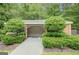 Charming brick pool house featuring an open design, surrounded by beautiful greenery, perfect for poolside relaxation at 305 Sherwood Rd, Fayetteville, GA 30215