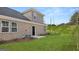 Spacious backyard with lush lawn, brick exterior, and freshly mulched landscape beds at 566 Silver Moon Dr, Loganville, GA 30052