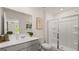Bright bathroom with modern vanity, framed mirror, and walk-in shower with glass door at 566 Silver Moon Dr, Loganville, GA 30052