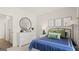 A bright bedroom featuring stylish decor, a round mirror, and sports-themed art at 566 Silver Moon Dr, Loganville, GA 30052