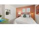 Inviting bedroom boasts a stylish accent wall, plush bedding, and colorful decor at 566 Silver Moon Dr, Loganville, GA 30052