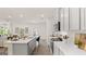 Open-concept kitchen features stainless steel appliances, a subway tile backsplash, and a view of the living area at 566 Silver Moon Dr, Loganville, GA 30052