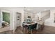 Eat-in kitchen with a dining nook features shaker cabinets, stainless appliances, and a view of the home's staircase at 566 Silver Moon Dr, Loganville, GA 30052