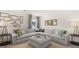 Bright living room with oversized sofa, decorative wall art, and neutral color palette at 566 Silver Moon Dr, Loganville, GA 30052