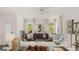 Bright living room with stylish furniture, a ceiling fan, and ample natural light, offering a cozy ambiance at 566 Silver Moon Dr, Loganville, GA 30052