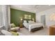 Main bedroom showcasing neutral tones, a ceiling fan, two chairs, and a doorway to an ensuite bathroom at 566 Silver Moon Dr, Loganville, GA 30052