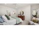 Cozy bedroom with a dresser, round mirror, chair, and view of the home's interior at 566 Silver Moon Dr, Loganville, GA 30052