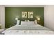 A cozy main bedroom showcases neutral tones, decorative wall art, bedside lamps, and a queen-sized bed at 566 Silver Moon Dr, Loganville, GA 30052