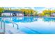 Sparkling blue community pool with lounge chairs, umbrellas, and mature trees nearby at 566 Silver Moon Dr, Loganville, GA 30052