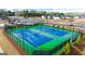 Dual fenced tennis courts surrounded by landscaping and trees at 566 Silver Moon Dr, Loganville, GA 30052