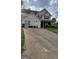 Charming two-story home with red shutters, well-maintained lawn, and a long driveway at 6265 Gemstone Ct, South Fulton, GA 30349