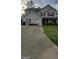 Charming two-story home with red shutters, well-maintained lawn, and a long driveway at 6265 Gemstone Ct, South Fulton, GA 30349