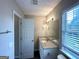 Bright bathroom featuring a granite countertop and a view from the window at 4320 Catalpa Way, Ellenwood, GA 30294