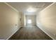 Neutral bedroom featuring a carpeted floor, window, and crisp white trim at 4320 Catalpa Way, Ellenwood, GA 30294