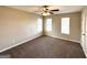 Cozy bedroom with plush carpeting, bright windows, and a ceiling fan for added comfort at 4320 Catalpa Way, Ellenwood, GA 30294
