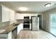 Well-equipped kitchen with stainless steel appliances, granite counters, and easy access to a deck at 4320 Catalpa Way, Ellenwood, GA 30294