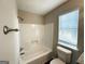 Standard white shower with chrome fixtures and a toilet next to a window at 4320 Catalpa Way, Ellenwood, GA 30294