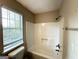 Standard shower with white tiling, chrome fixtures, and a window with blinds at 4320 Catalpa Way, Ellenwood, GA 30294