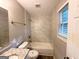 Bright bathroom with white tiled shower and granite vanity top with dark wood-look floors at 2784 Rockdale Dr, Decatur, GA 30034