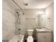 Updated bathroom featuring tiled shower, modern fixtures, and a granite-topped vanity at 2784 Rockdale Dr, Decatur, GA 30034