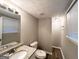 Well-lit bathroom with granite vanity and white cabinets, complemented by wood-look vinyl flooring at 2784 Rockdale Dr, Decatur, GA 30034