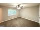 Comfortable bedroom featuring a ceiling fan, plush carpet, and natural light at 2784 Rockdale Dr, Decatur, GA 30034