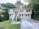 Inviting exterior of home with gray siding, red door, and landscaped front yard at 2784 Rockdale Dr, Decatur, GA 30034