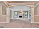 Finished basement area with fireplace and elegant archway and pillar design at 115 Robinwood Ct, Fayetteville, GA 30214