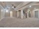 Finished basement with archways, pillars and stairwell to upper level at 115 Robinwood Ct, Fayetteville, GA 30214