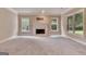 Finished basement area with fireplace and multiple windows providing natural light at 115 Robinwood Ct, Fayetteville, GA 30214