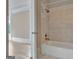 A bathroom with modern fixtures and an elegant bathtub with tiled walls at 115 Robinwood Ct, Fayetteville, GA 30214