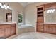 Bathroom with a double sink vanity, soaking tub, and natural light at 115 Robinwood Ct, Fayetteville, GA 30214