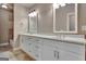 Bathroom featuring double sink vanity with white cabinets, mirrors, and tile flooring at 115 Robinwood Ct, Fayetteville, GA 30214