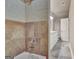 Bathroom featuring a tiled tub surround plus a view into the double vanity area at 115 Robinwood Ct, Fayetteville, GA 30214