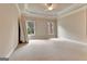 Spacious bedroom with a trey ceiling, fan, and large windows for plenty of light at 115 Robinwood Ct, Fayetteville, GA 30214