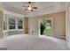 Spacious bedroom features tray ceilings, bay window, and french doors to the backyard at 115 Robinwood Ct, Fayetteville, GA 30214