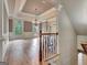 Dining room view from staircase, with hardwood floors and an elegant chandelier at 115 Robinwood Ct, Fayetteville, GA 30214